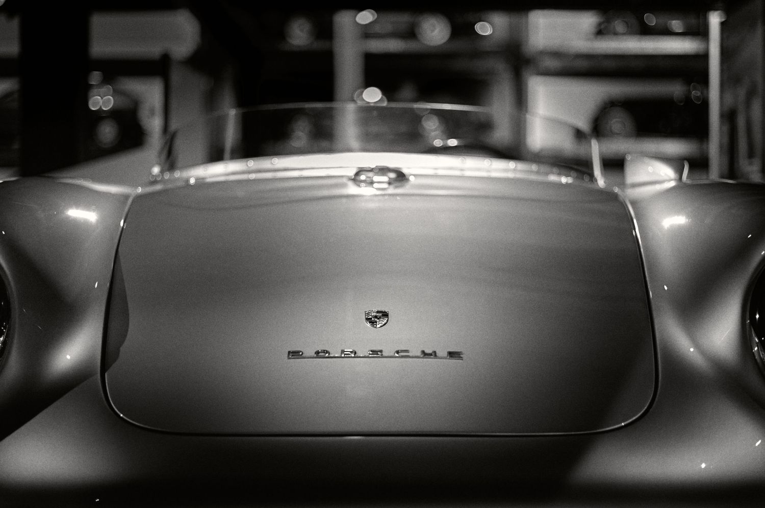 Rear detail of a classic Porsche showing curved bodywork and badge.