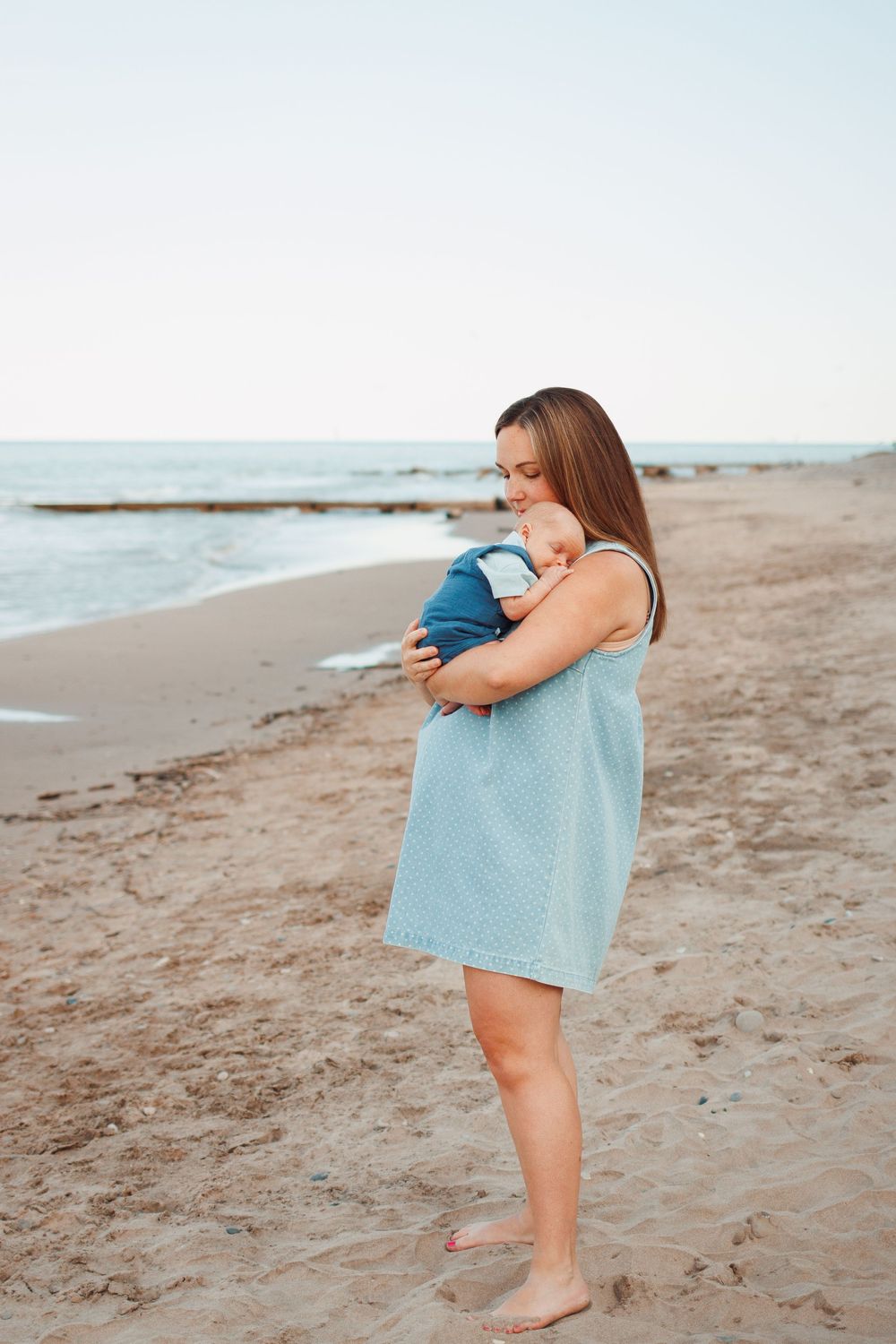 Mother holding baby during family photography session
