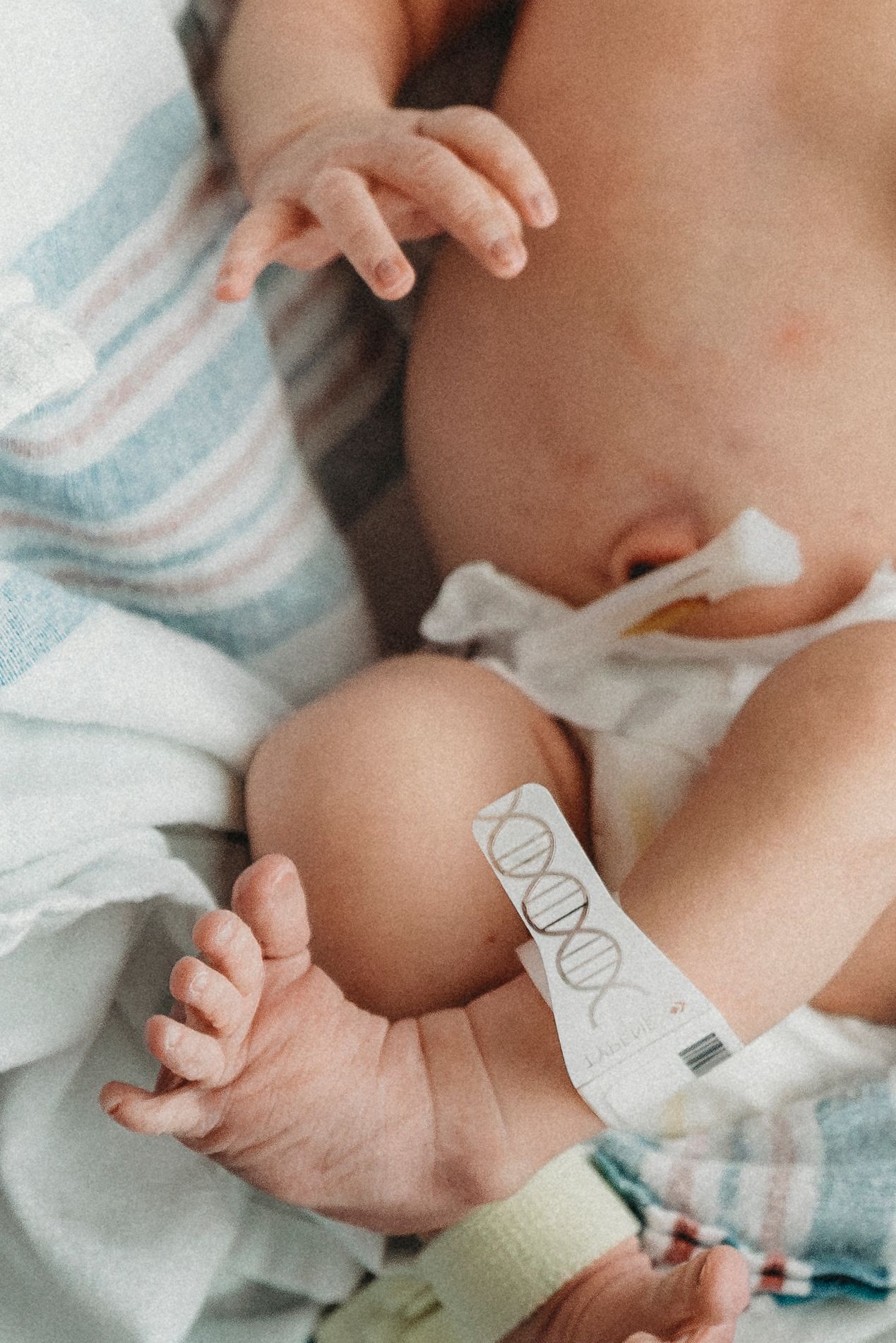 Close-up shot of newborn baby details with hospital ID bracelet.