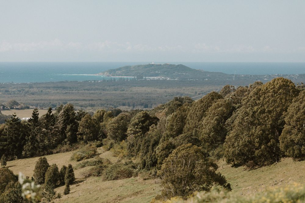 Scenic coastal landscape with rolling hills and distant ocean views.