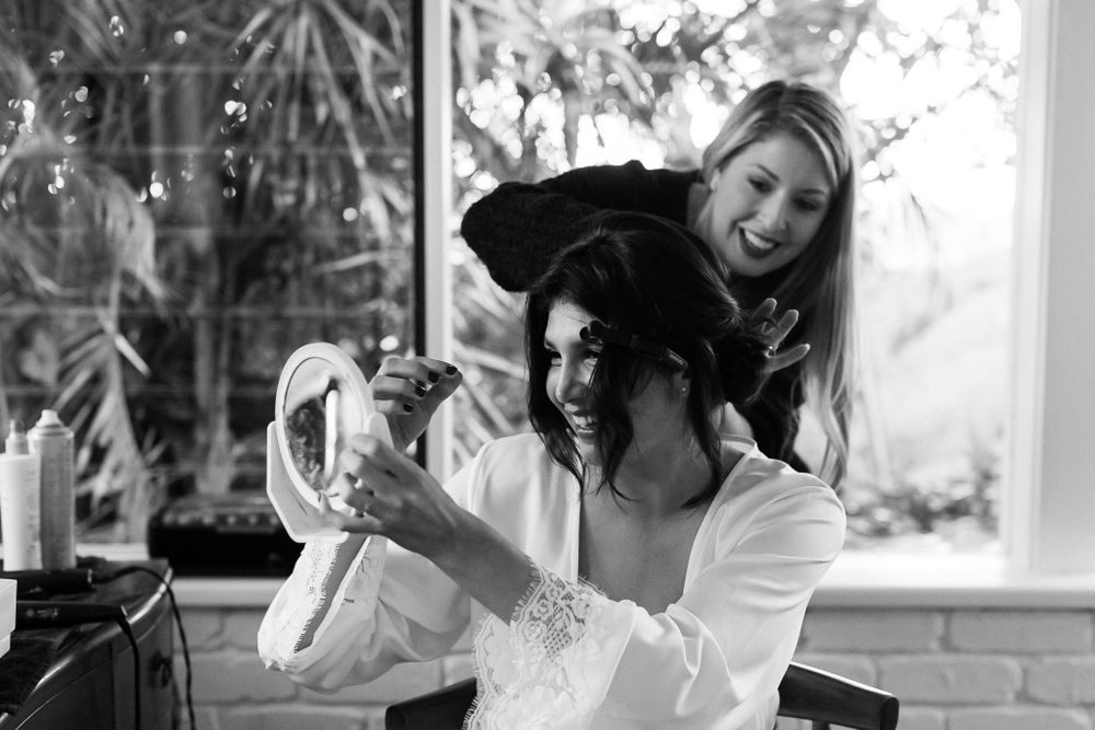 A candid moment of wedding day preparations by a bright window.