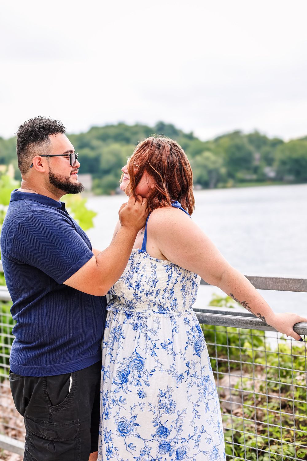 A candid image of a couple by a lake.