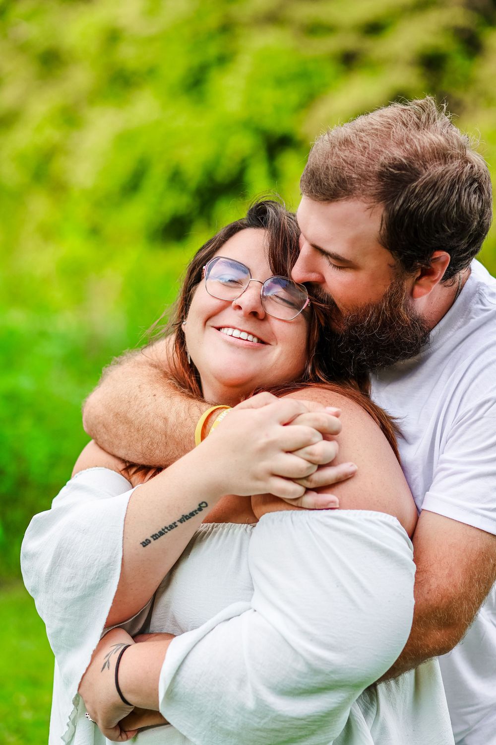 A lifestyle image of a young couple holding each other at Tommy Schumpert Park, Knoxville TN.