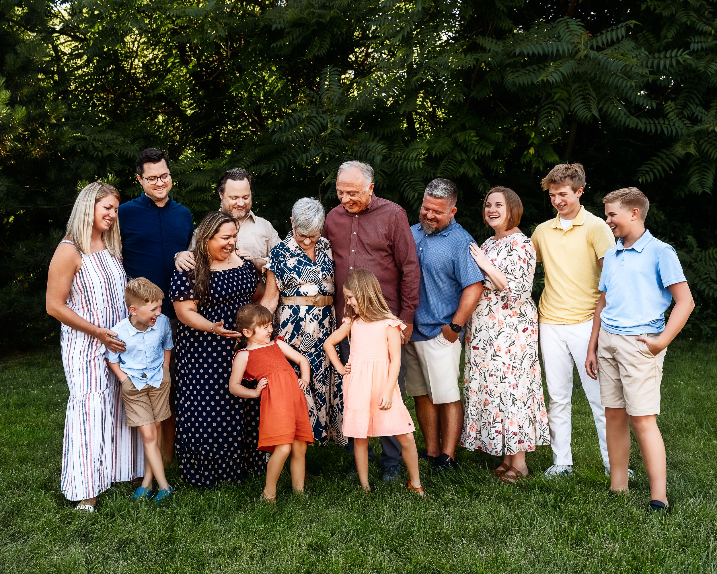 A series of five outdoor family portrait photos showing a group of people standing together in a garden setting.