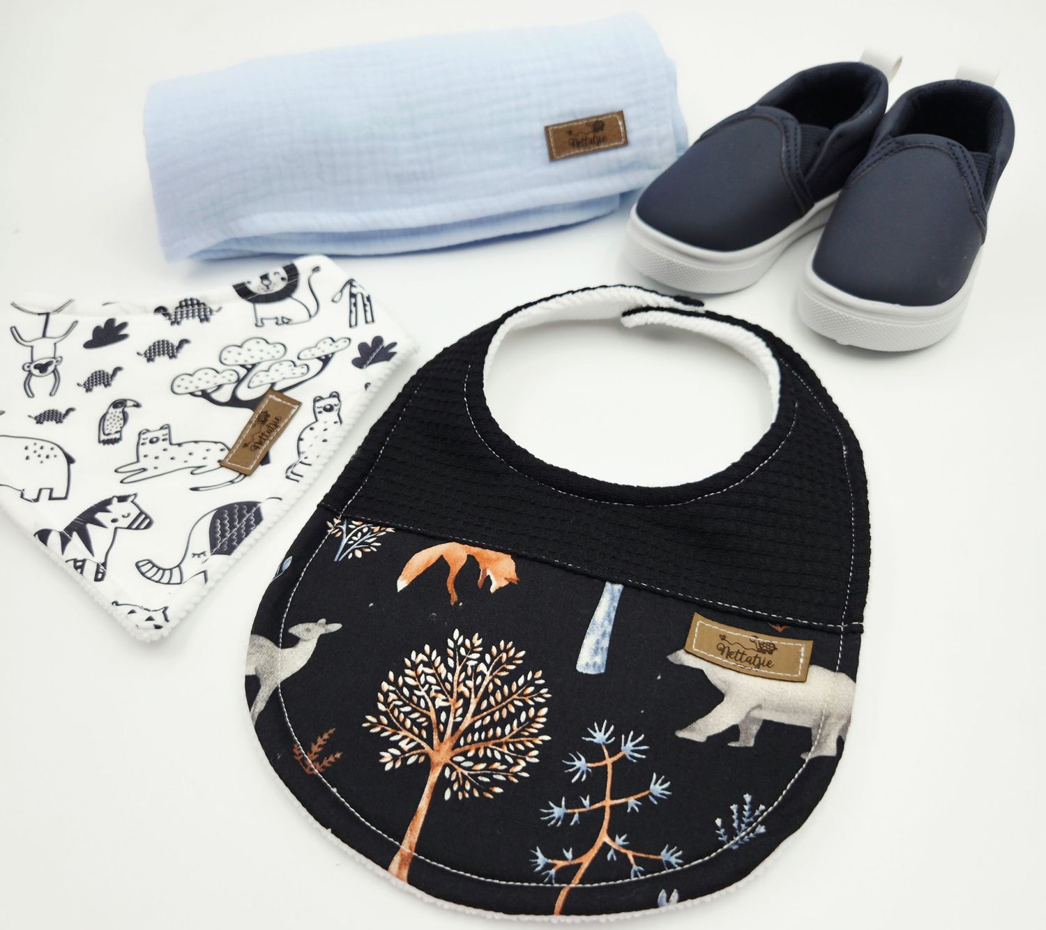 Black and white woodland themed baby bibs and shoes with forest animal prints.
