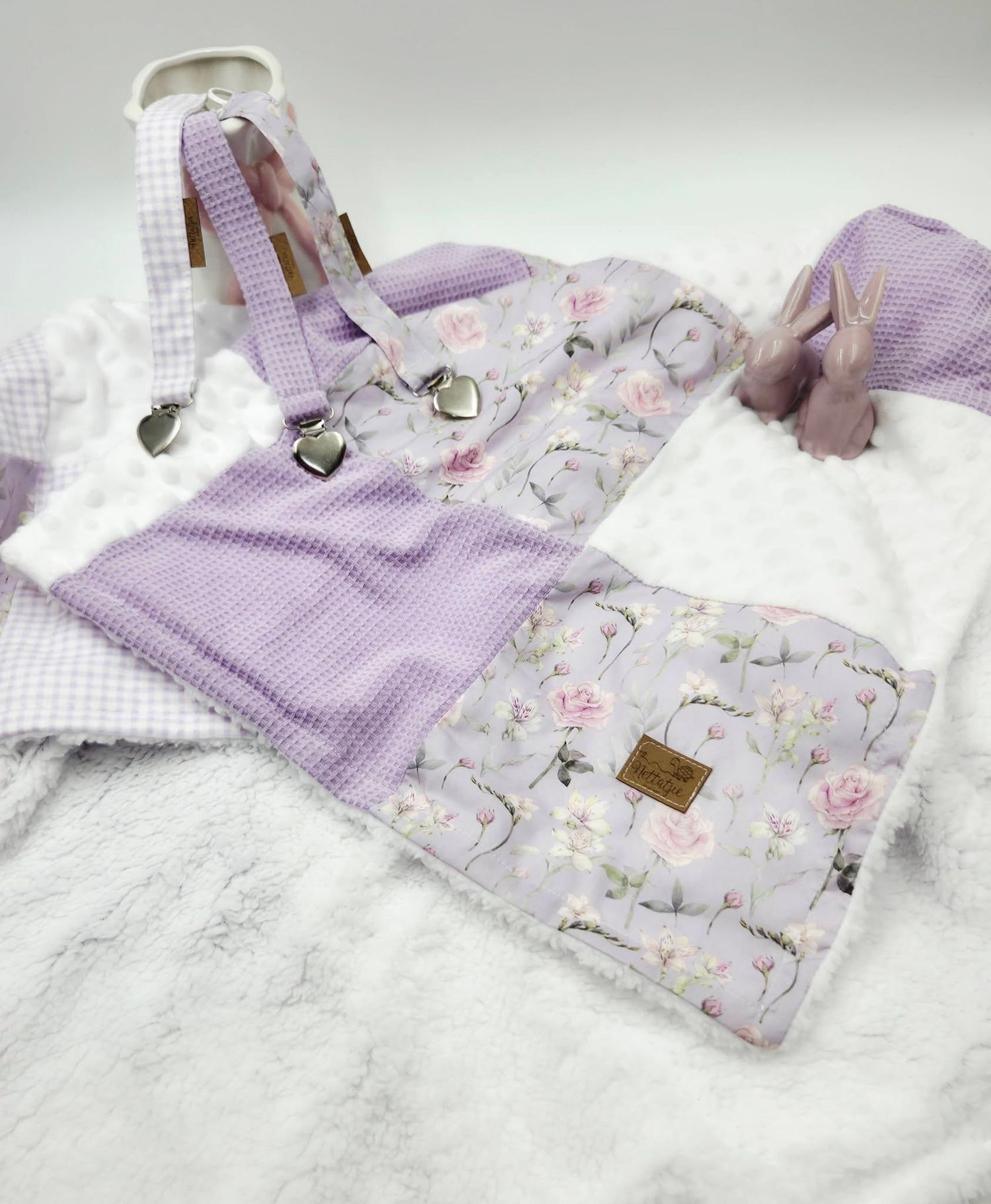 Purple floral baby overalls set with suspenders, matching bib, and soft white blanket, perfect for infant girls.
