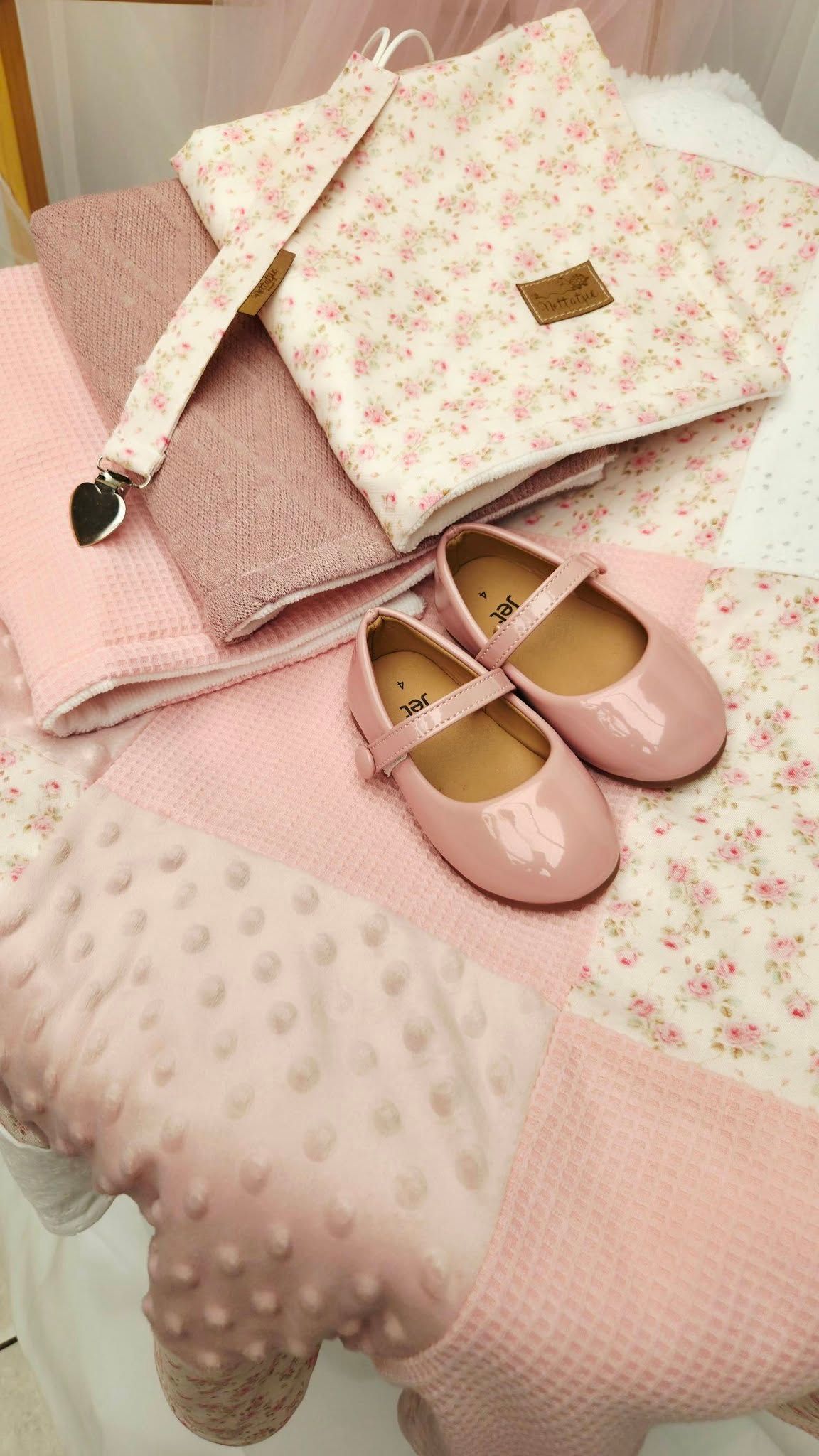 Pink baby girl set featuring patent Mary Jane shoes, floral changing bag, waffle blanket, and bobble play mat.