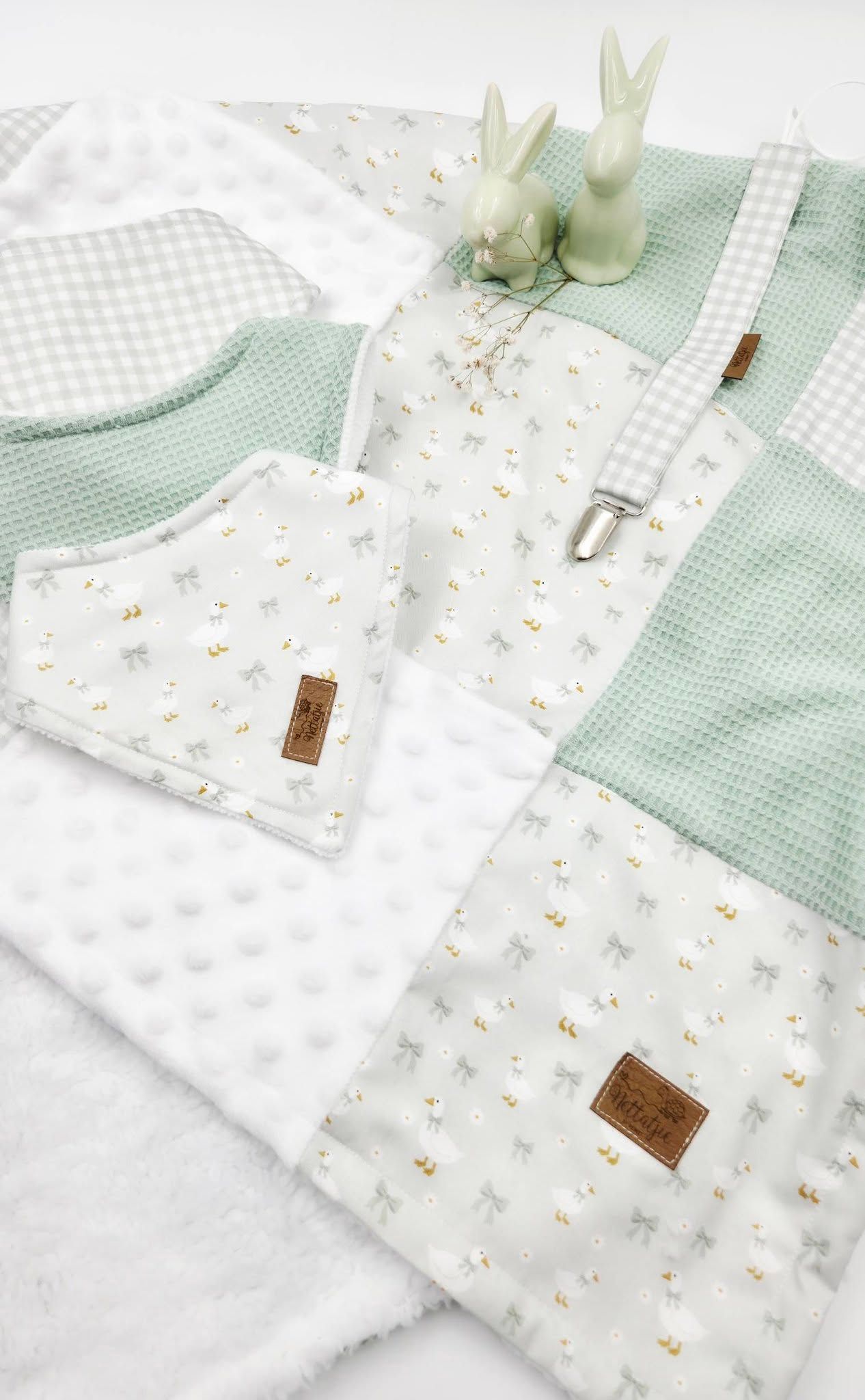 Mint green and white baby gift set with bunny print fabric, waffle texture, and minky dot blanket, styled with ceramic rabbit figurines.