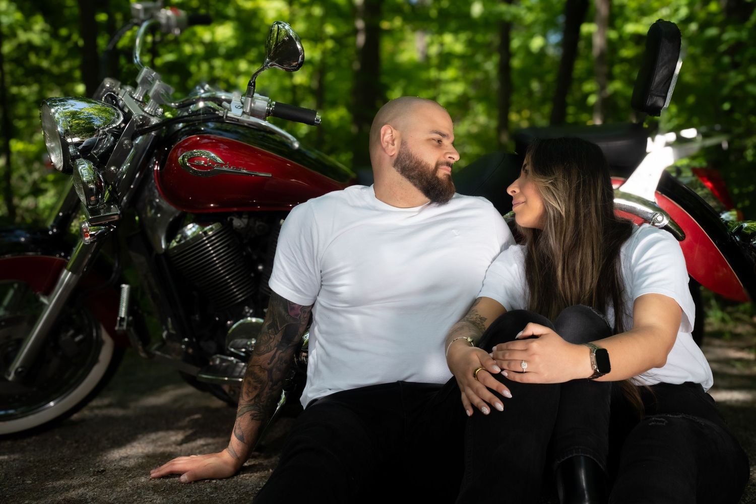 Romantic outdoor photoshoot in a lush green forest setting.