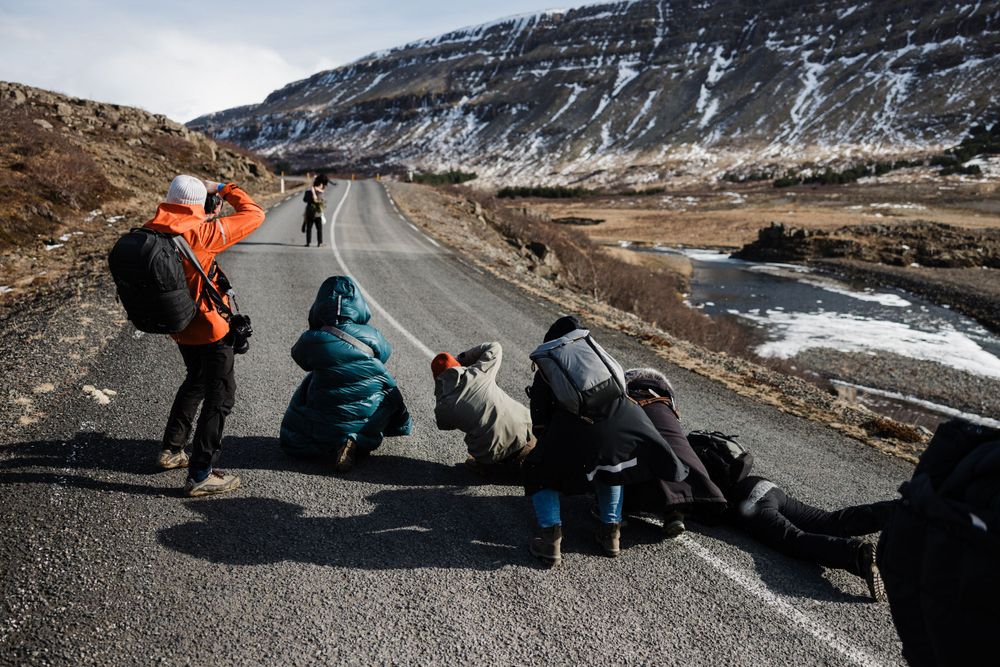 Photographers shooting a wedding couple in Iceland in a workshop in the middle of the road