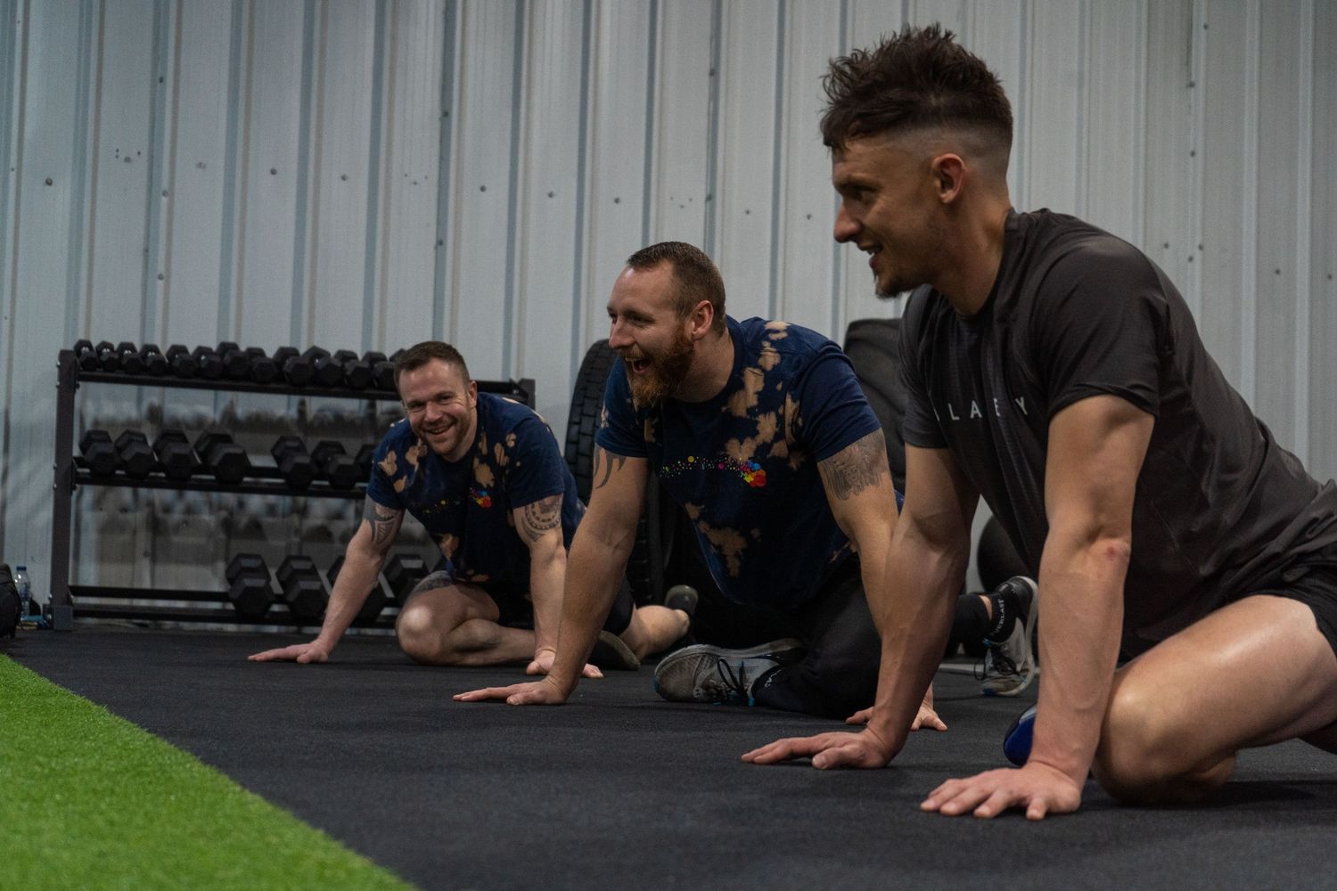 A group of men stretching, smiling and having a laugh