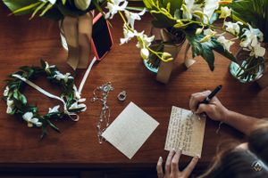 Wedding stationery and floral arrangements on a wooden table, Papaya Playa Tulum Wedding.
