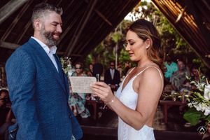 Newlyweds share joyful laughter during intimate outdoor wedding celebration, Papaya Playa Tulum Wedding.