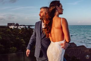 Couple shares intimate moment against ocean backdrop during golden hour wedding photoshoot, Papaya Playa Tulum Wedding.