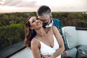 Romantic sunset scene with couples embracing in a tropical wedding setting, Papaya Playa Tulum Wedding.