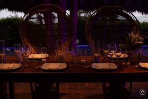 Wedding reception under ornate arches with romantic ambient lighting and candles, Papaya Playa Tulum Wedding.