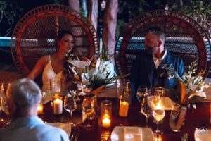 Elegant candlelit wedding reception tables set with floral centerpieces and ambient lighting, Papaya Playa Tulum Wedding.