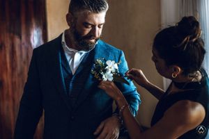 Wedding preparation scene in a dimly lit room with formal attire, Papaya Playa Tulum Wedding.