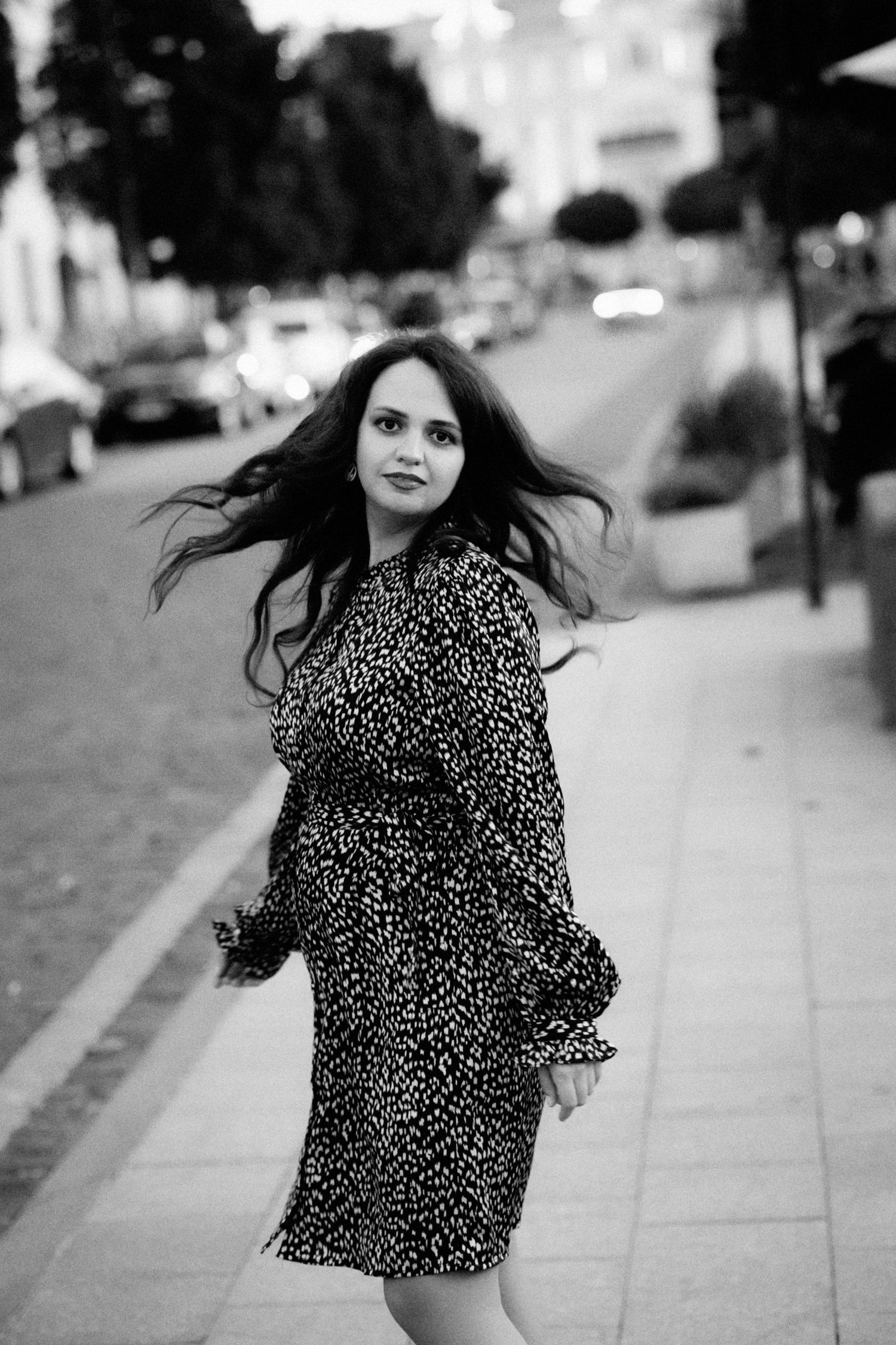 black and white portrait of a spinning girl in a dress