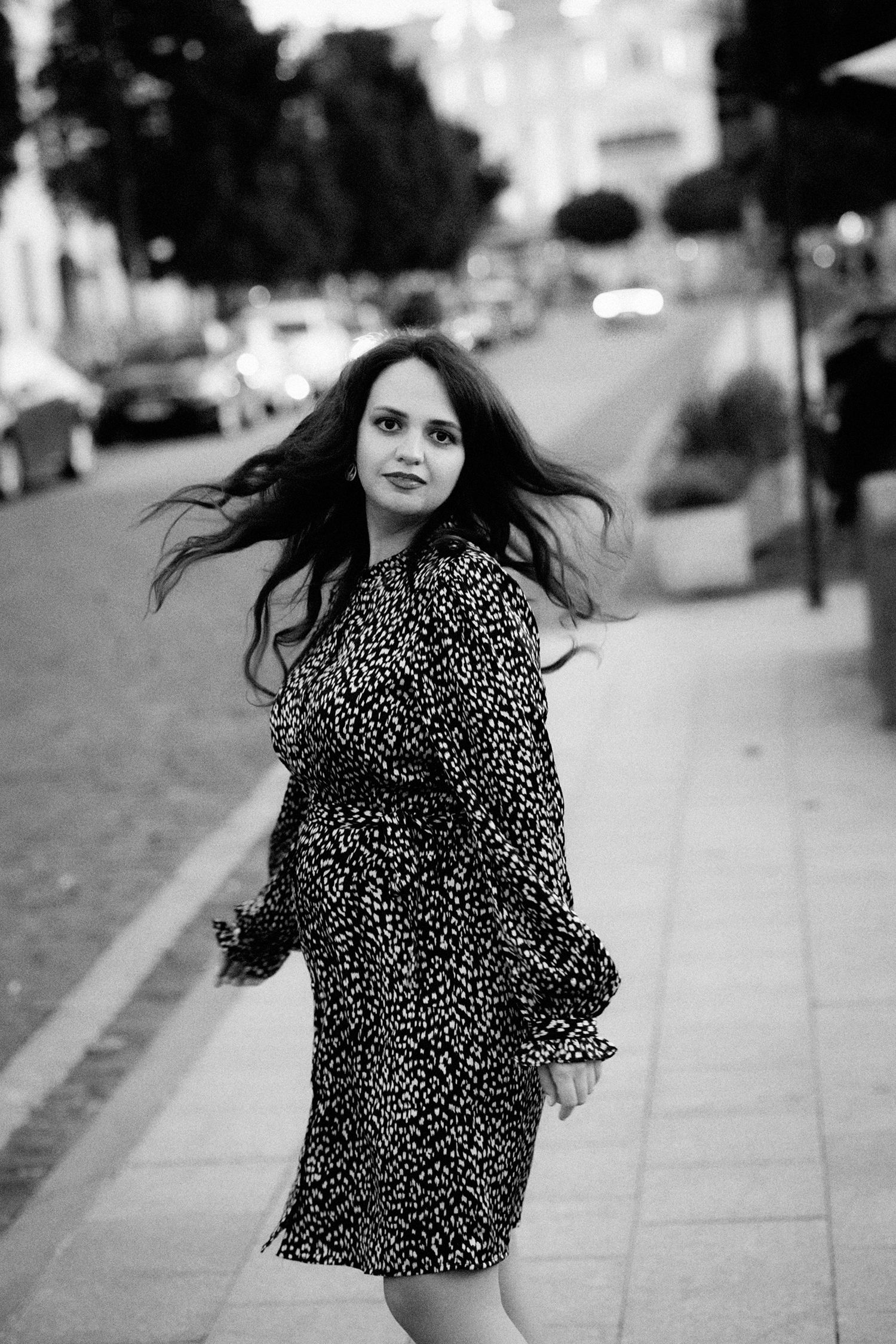black and white portrait of a spinning girl in a dress