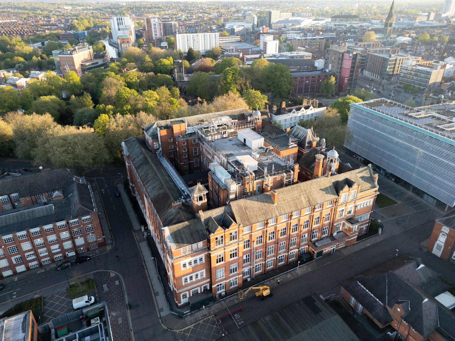 Bird's eye view of ornate Victorian-era buildings surrounded by modern urban development.
