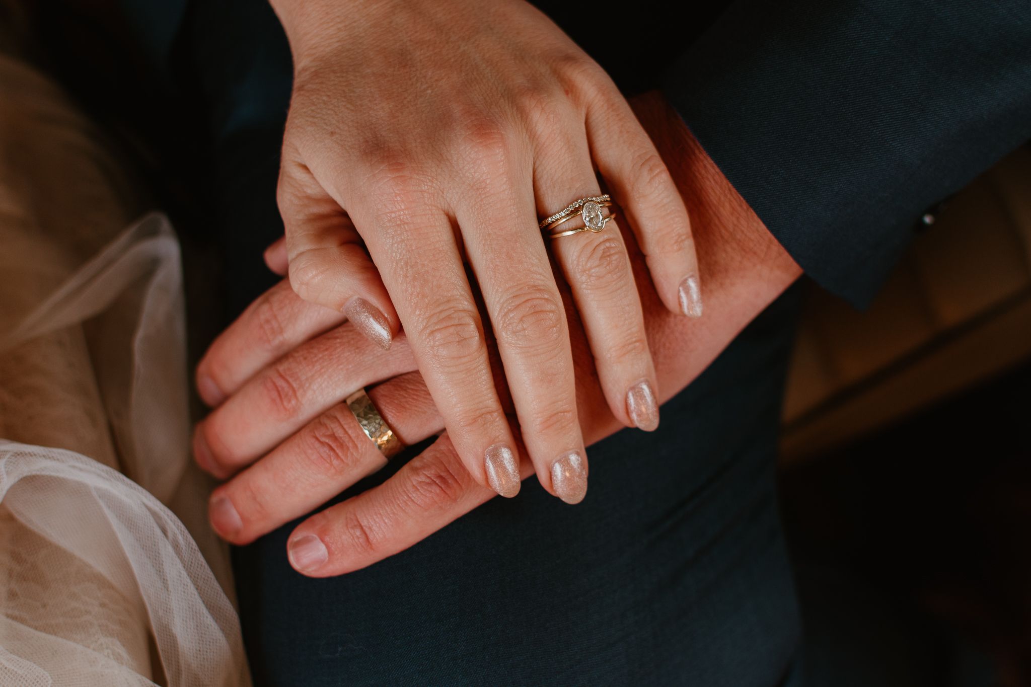 Close-up shots of hands with wedding rings against a dark background.