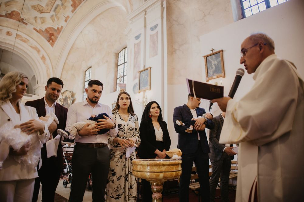 Religious ceremony taking place in an ornate church with vaulted ceilings.