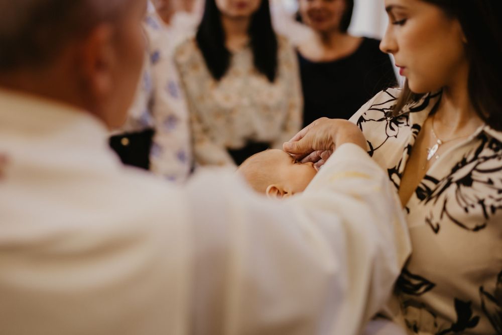 Holy water is administered during a traditional baptism ceremony.