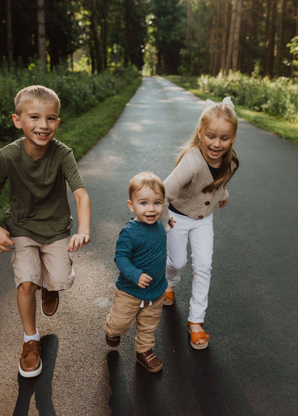 Playful chase scene on a forest path with natural lighting filtering through trees.