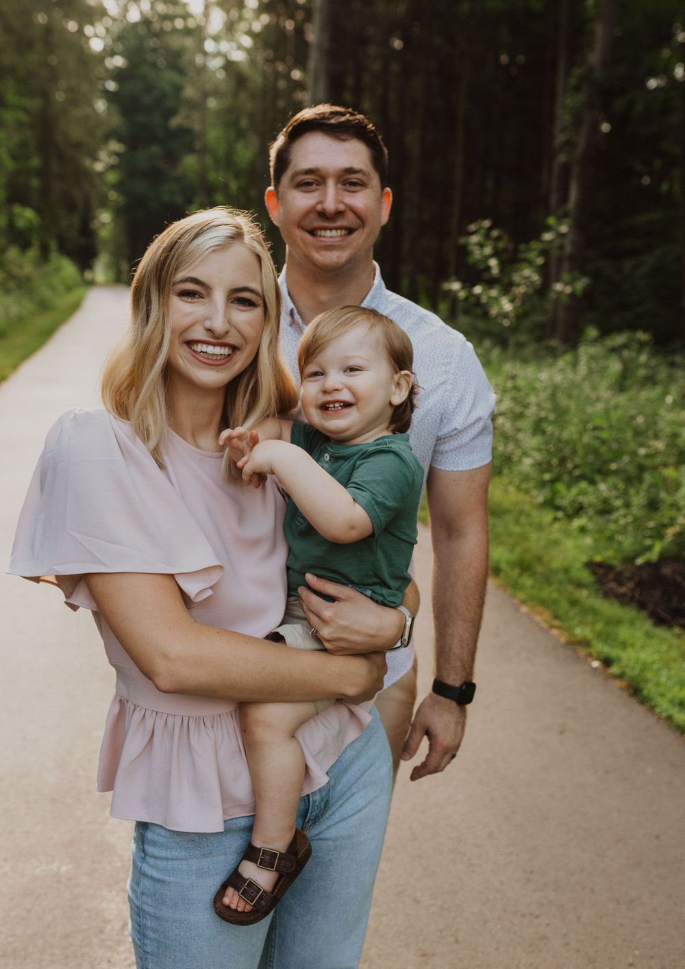 Joyful family interactions on a paved woodland trail.