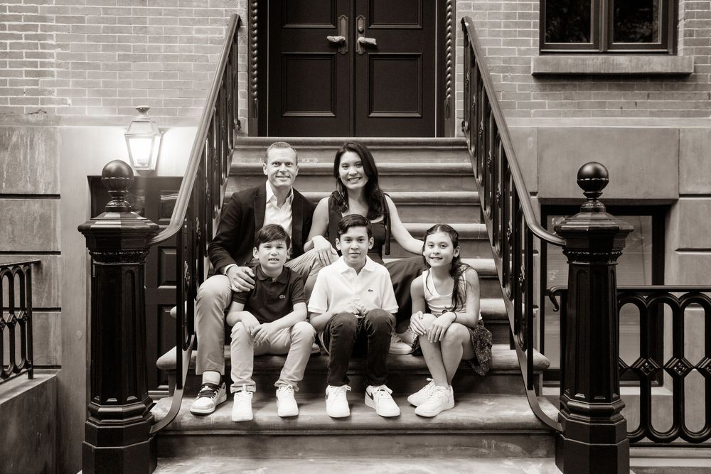 A collection of posed artistic black and white photos taken on brick building steps with iron railings.