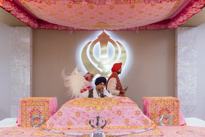 Sikh couple doing phrase at the Gurdwara..