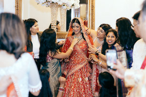 Indian bride in Red lehenga with friends before her wedding in Houston.