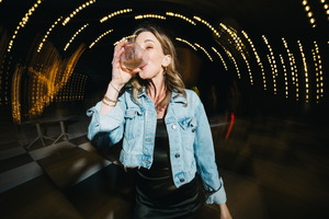 A sequence of dimly lit photos showing someone in a denim jacket against dark tunnel lighting with bokeh effects.