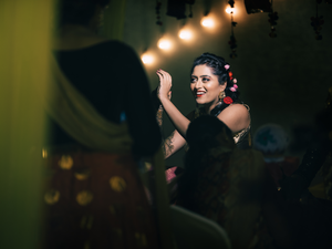 Bride dances gracefully under warm lighting at an Mehendi evening event.
