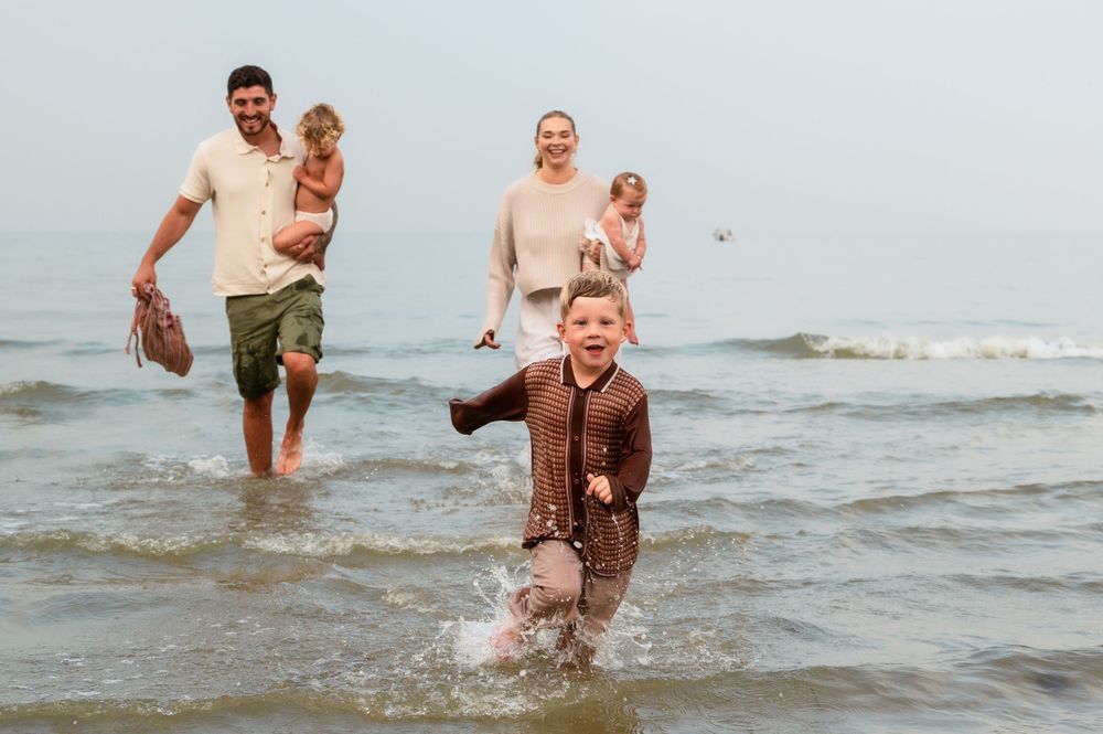 A fun family beach day with waves splashing and everyone enjoying the water.