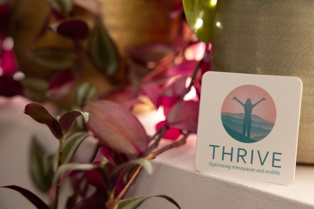 A collage of pink floral arrangements with the Thrive logo visible in a business setting.