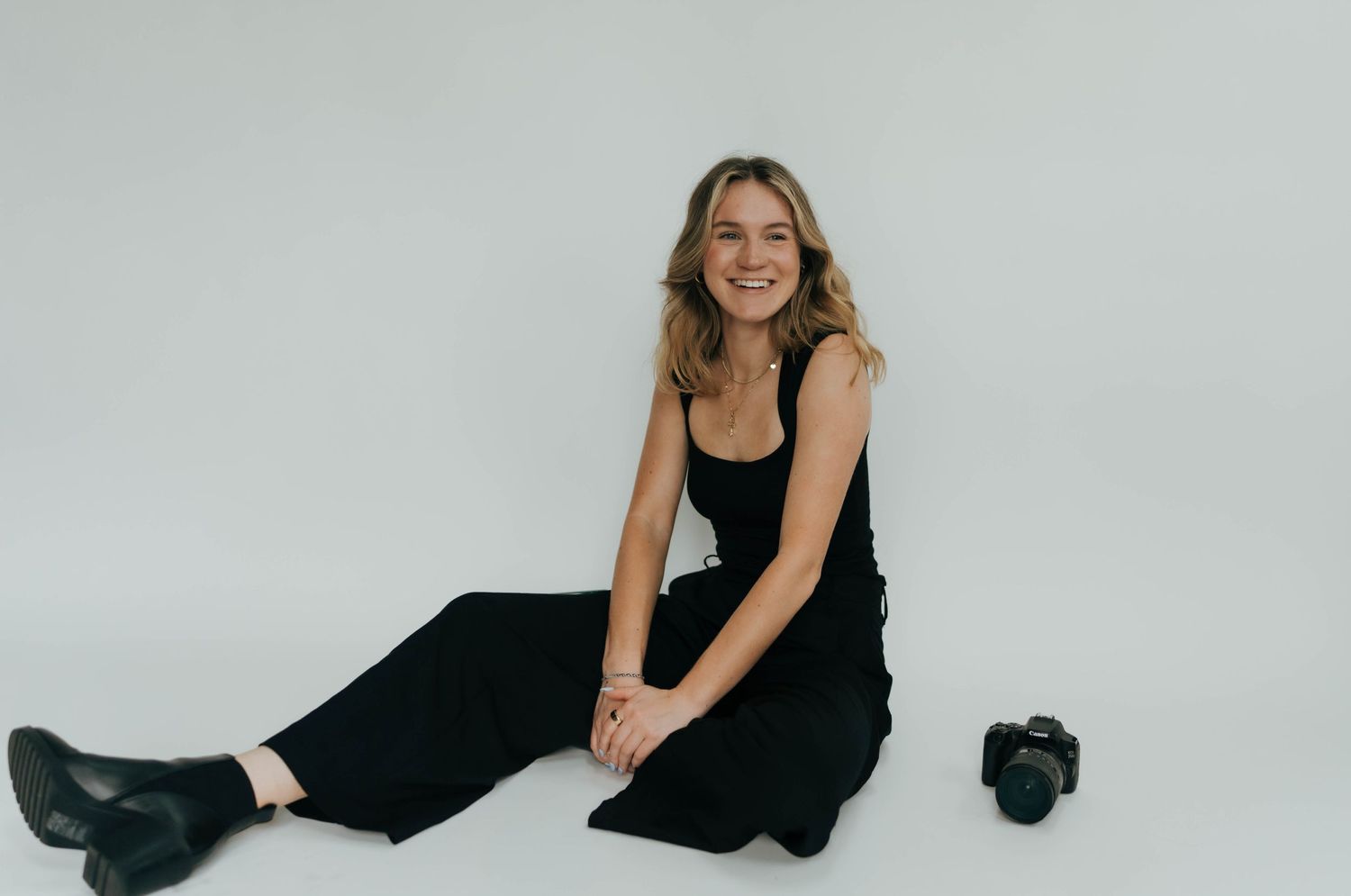 photographer biography black outfit with white backdrop portrait photoshoot branding photos