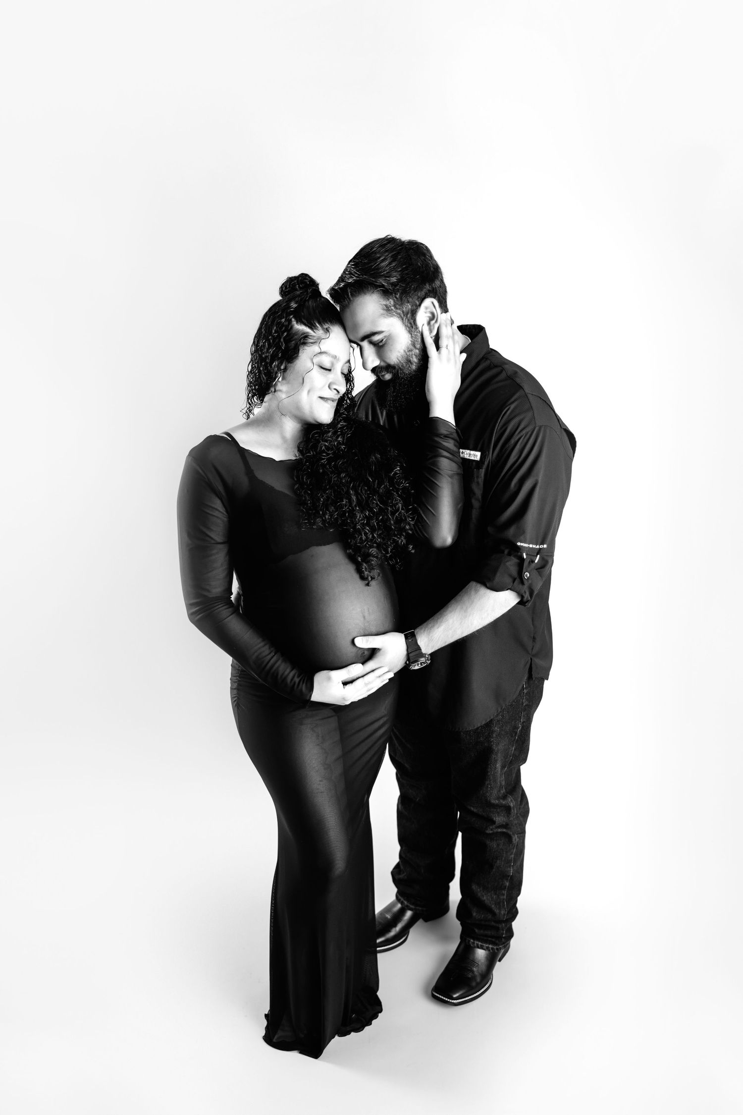 Black and white artistic sequence showing a romantic couple in intimate poses against a white background.  Middle TN Maternity