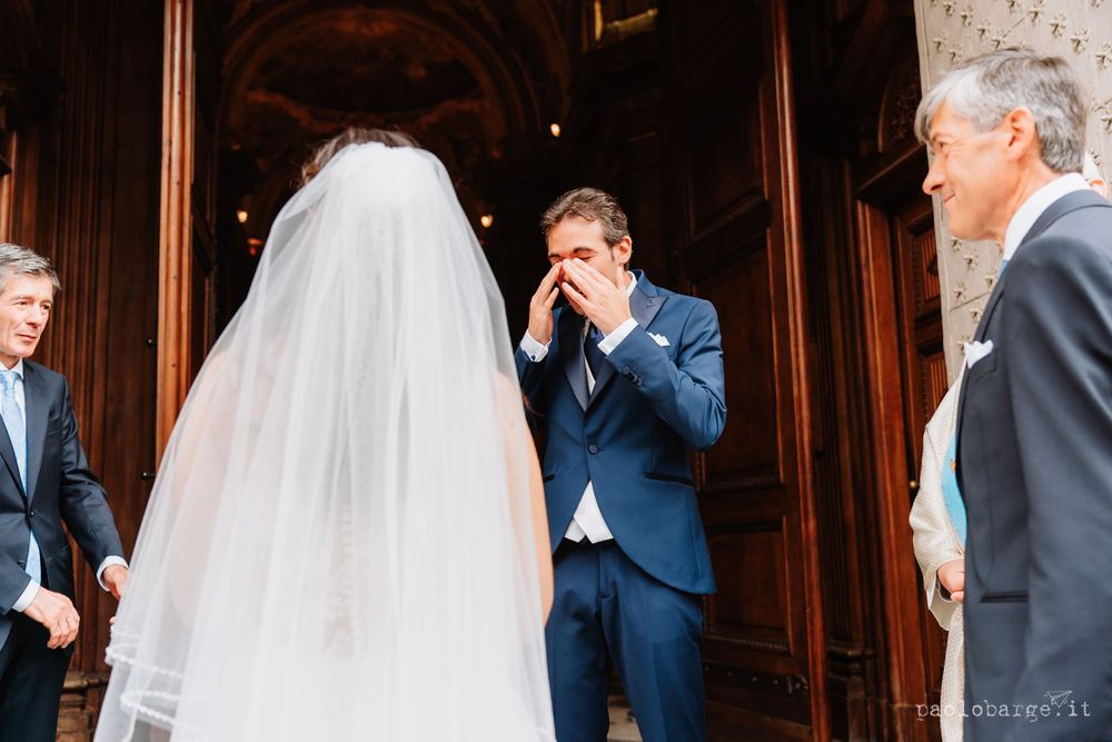 An emotional moment during a wedding ceremony as bride and groom interact.