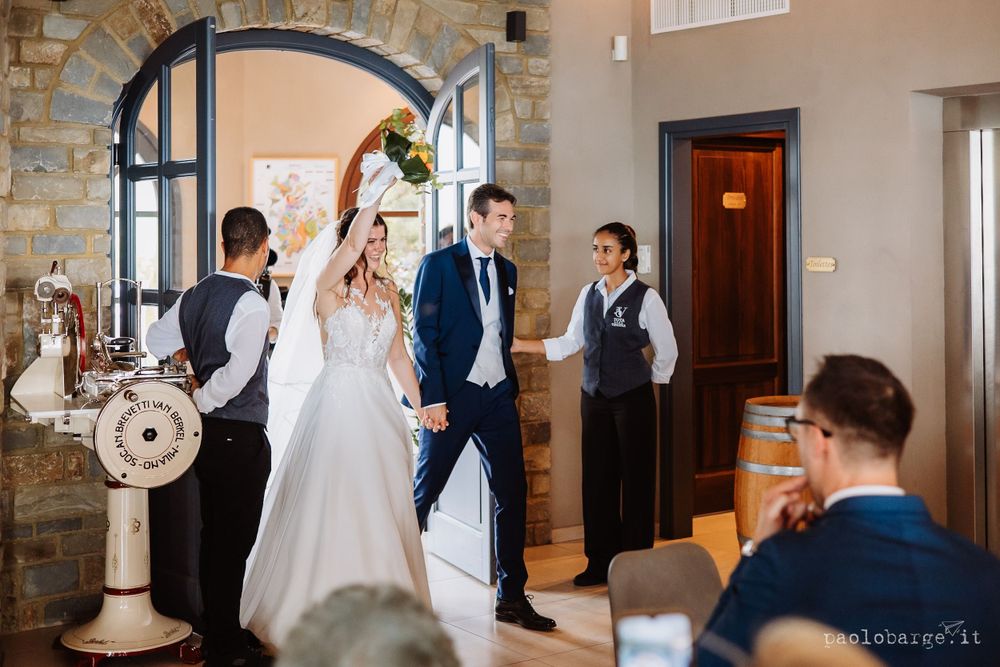 Elegant wedding ceremony in a rustic stone-walled venue with decorative architectural details.