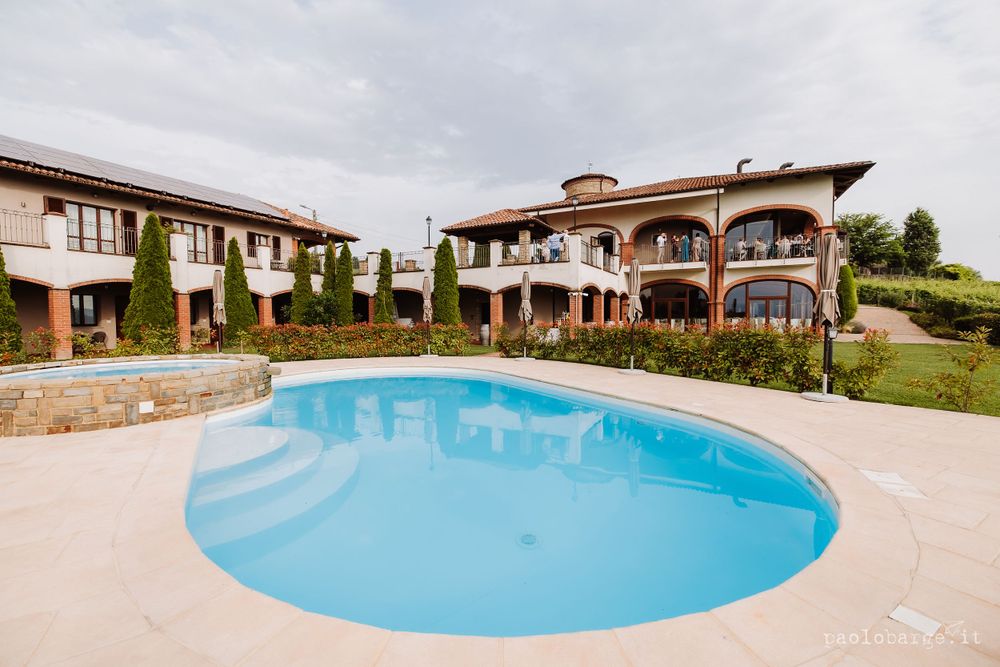 Mediterranean-style villa with curved swimming pool surrounded by landscaped grounds.