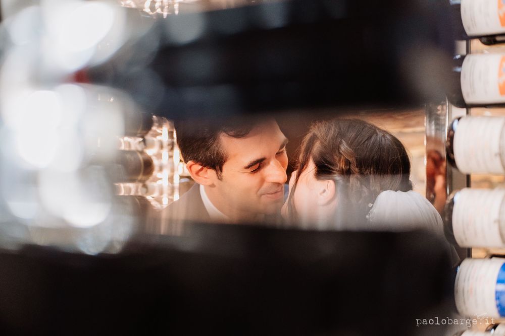 Artistic wedding photograph captured through decorative architectural elements.
