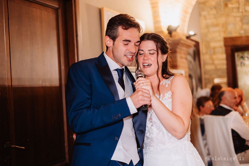 A celebratory moment shared during wedding reception under brick archways.
