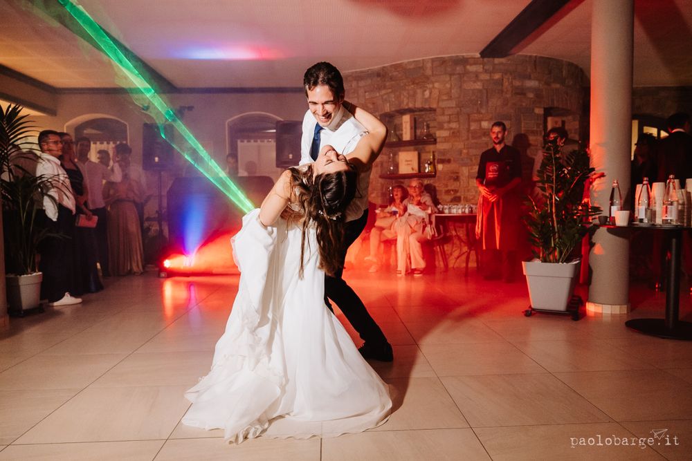 Couple dances together under ethereal green lighting during their wedding celebration.