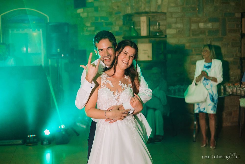 Romantic slow dance moment captured during an evening wedding reception.