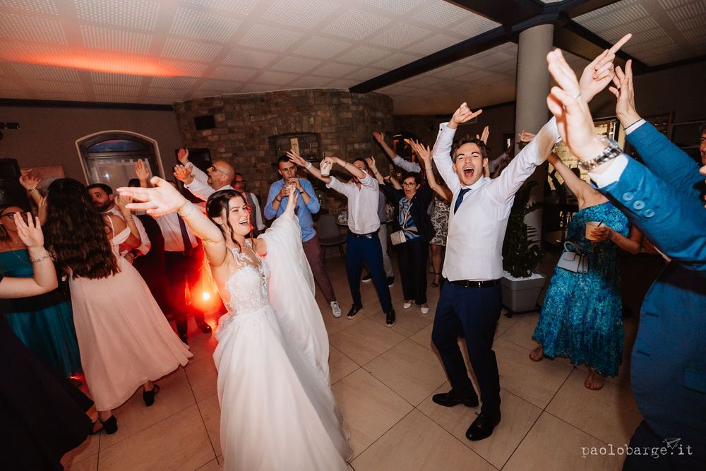 Energetic dancing and celebration captured during a lively wedding reception party.