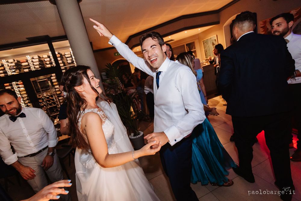 Energetic dancing and celebration during wedding reception party.