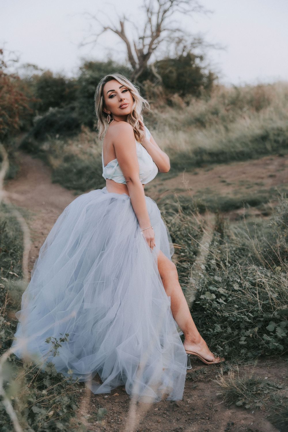 Beautiful white female dressed in blue and purple hue dress at Hadleigh Castle in Essex
