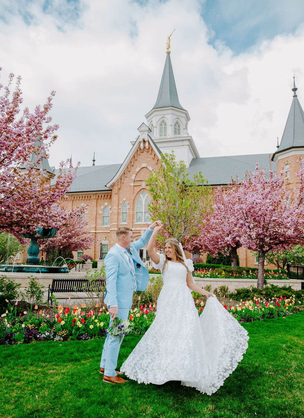 Spring wedding photos at Provo City Center Utah Temple with blooming cherry blossoms and tulip gardens.